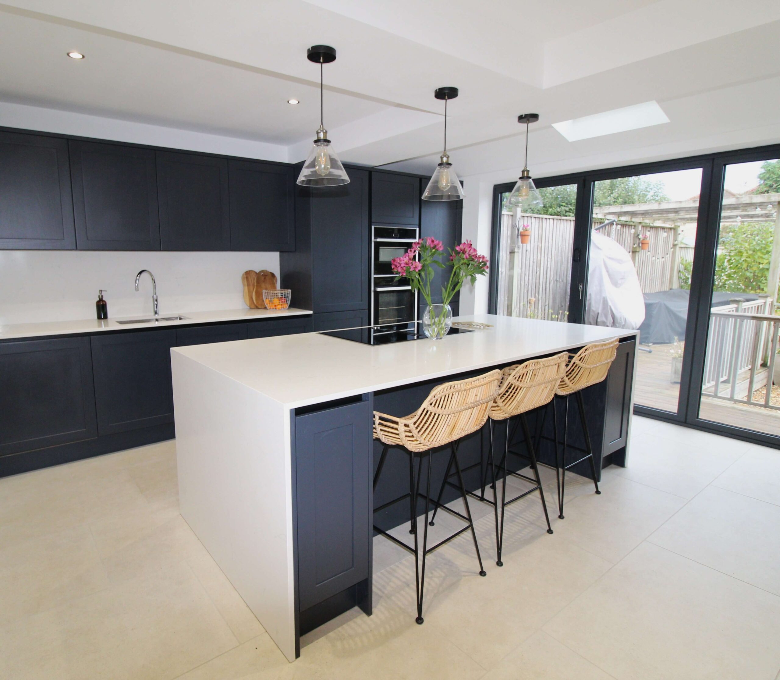 Shaker kitchen pained in charcoal with white quartz worktop