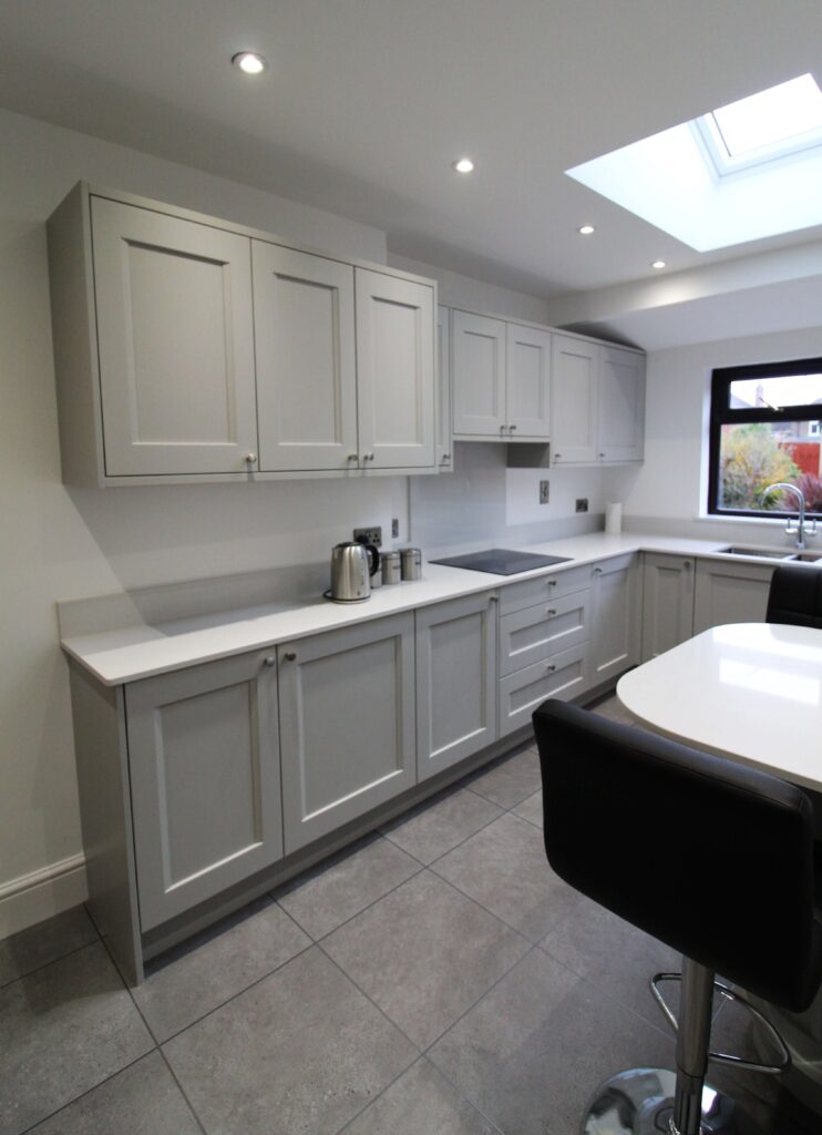 Soft grey shaker kitchen with black bar stool