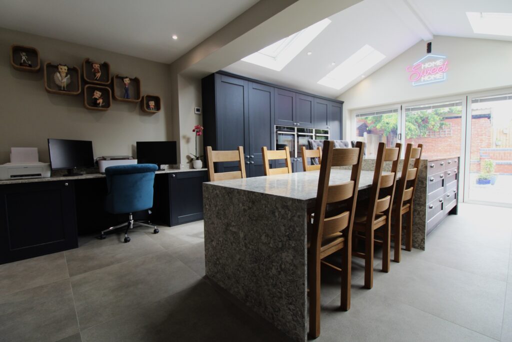 blue vinyl shaker kitchen with quartz worktop on centre island