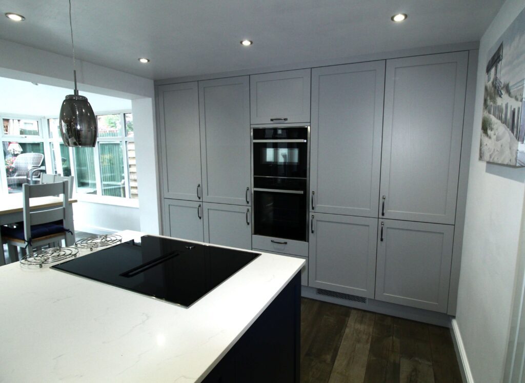 Soft grey shaker kitchen units with integrated neff appliances