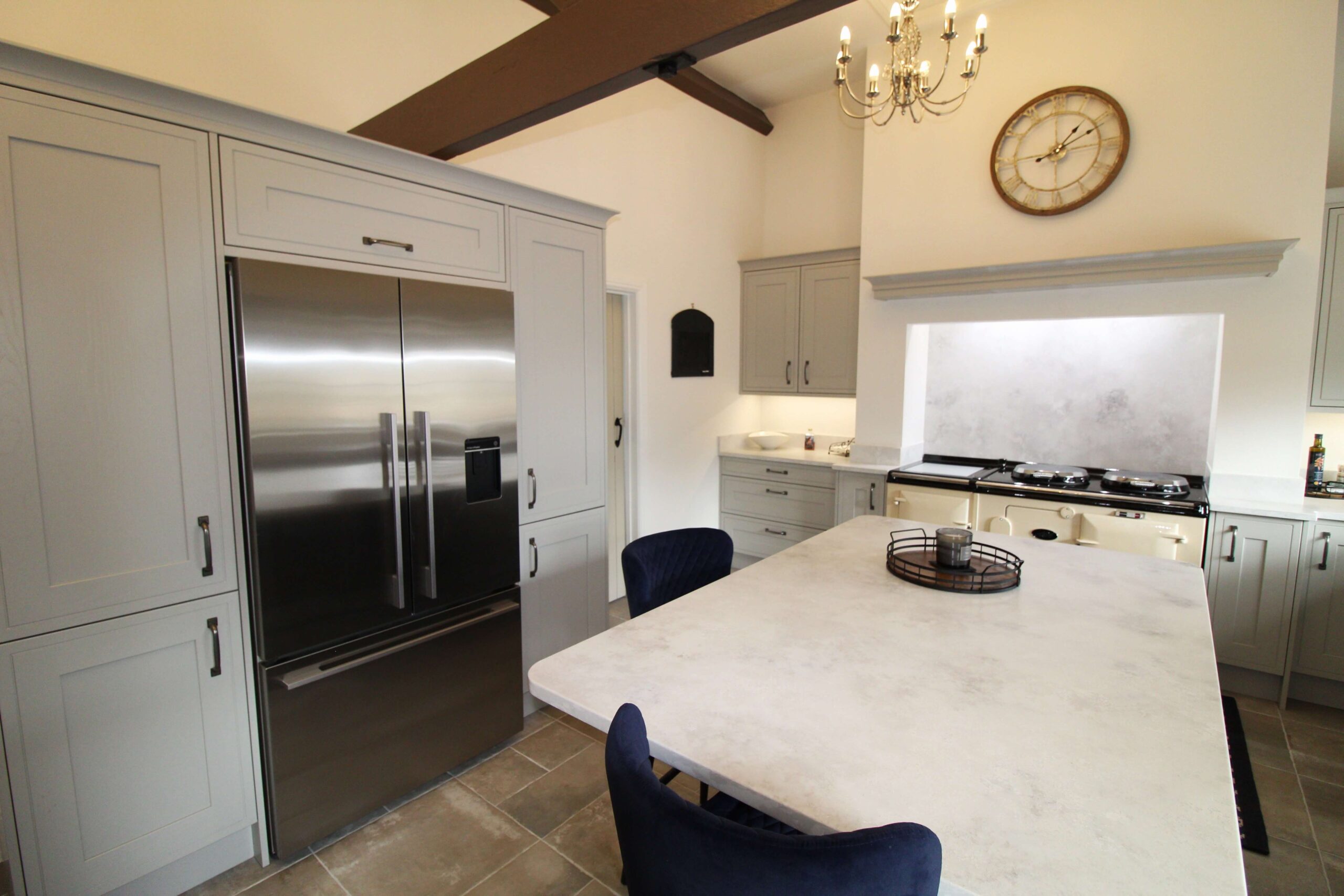 Grey painted kitchen with quartz worktop and aga