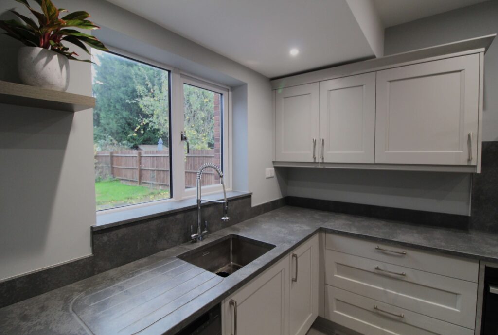 soft grey shaker kitchen with concrete quartz worktop